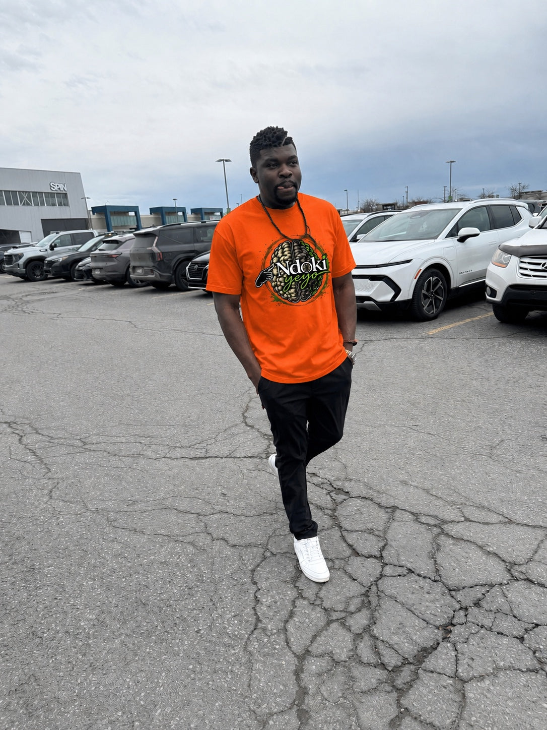Ndoki Yeyo orange shirt street look